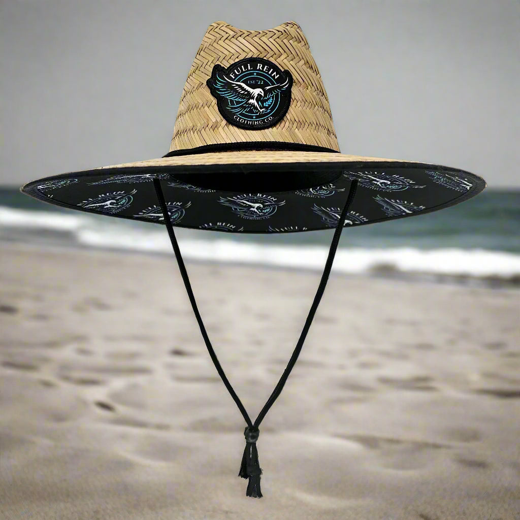 Black surfboard with a straw bag on a white background