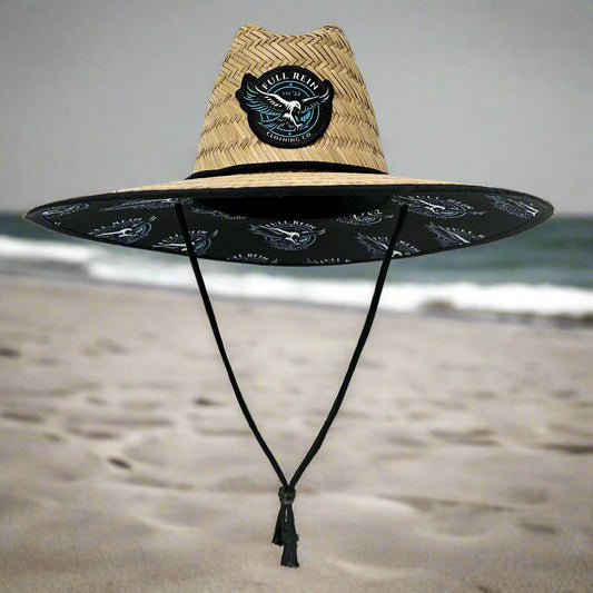 Black surfboard with a straw bag on a white background